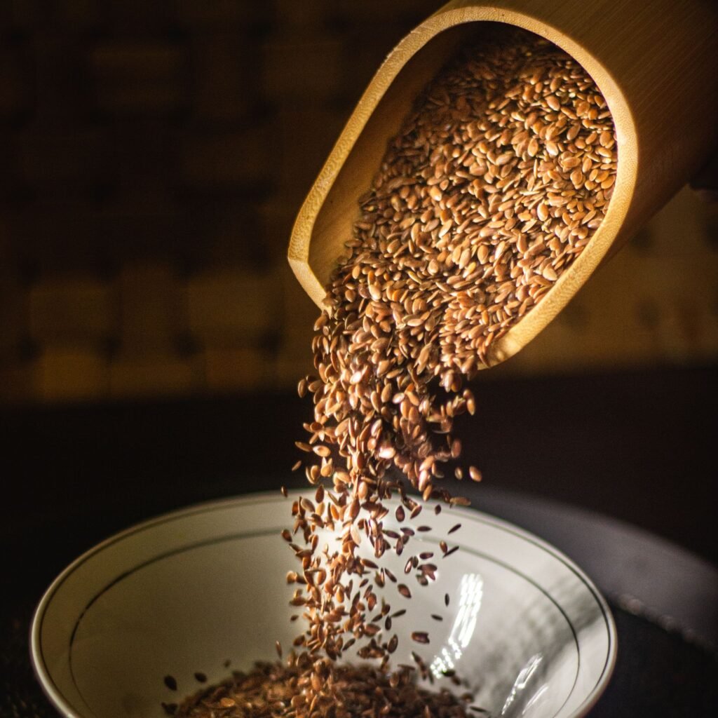 Flax seeds being poured into a bowl, highlighting a nutritious breakfast option.
